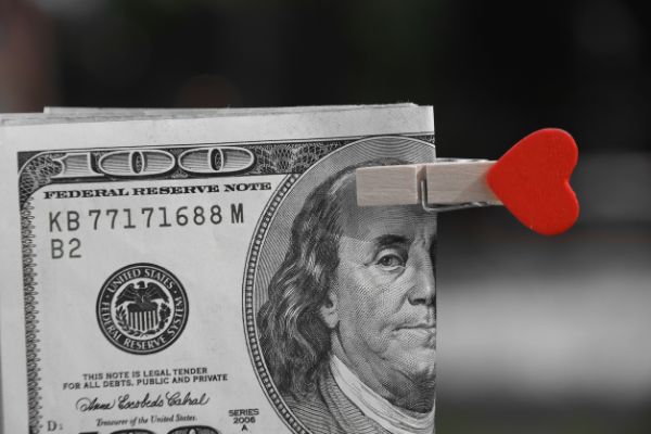 100 dollar bill with heart shaped clip