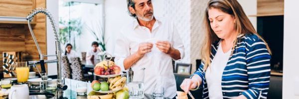 Husband and wife cooking in kitchen